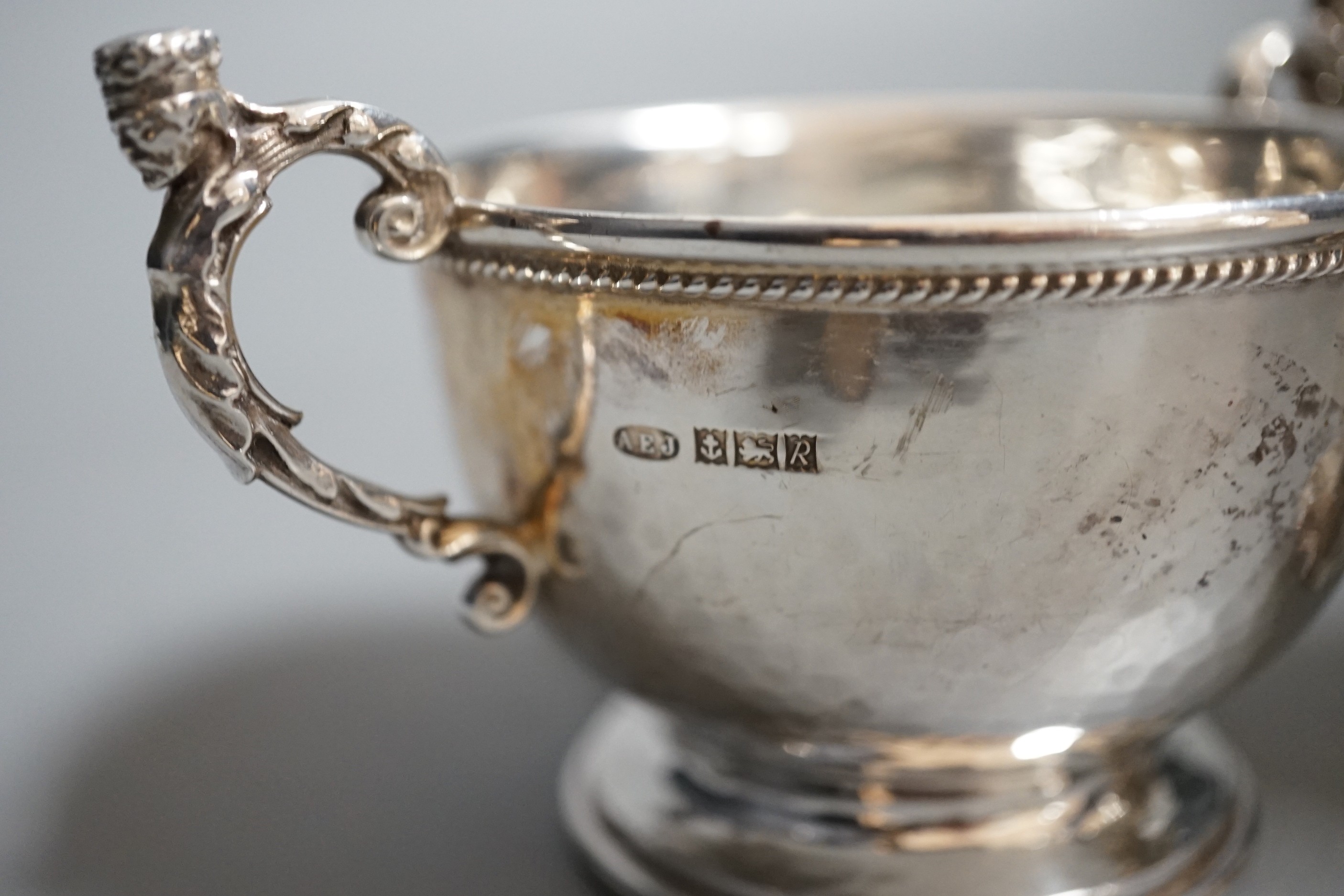 A Victorian embossed silver christening cup, Edward & John Barnard, London, 1848, 11cm and a modern small planished twin handled bowl by A.E. Jones Ltd.